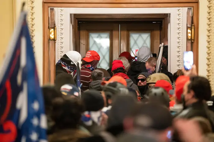 Supporters of US President Donald J. Trump outside the door to the House chamber after breaching Capitol security in Washington, DC,